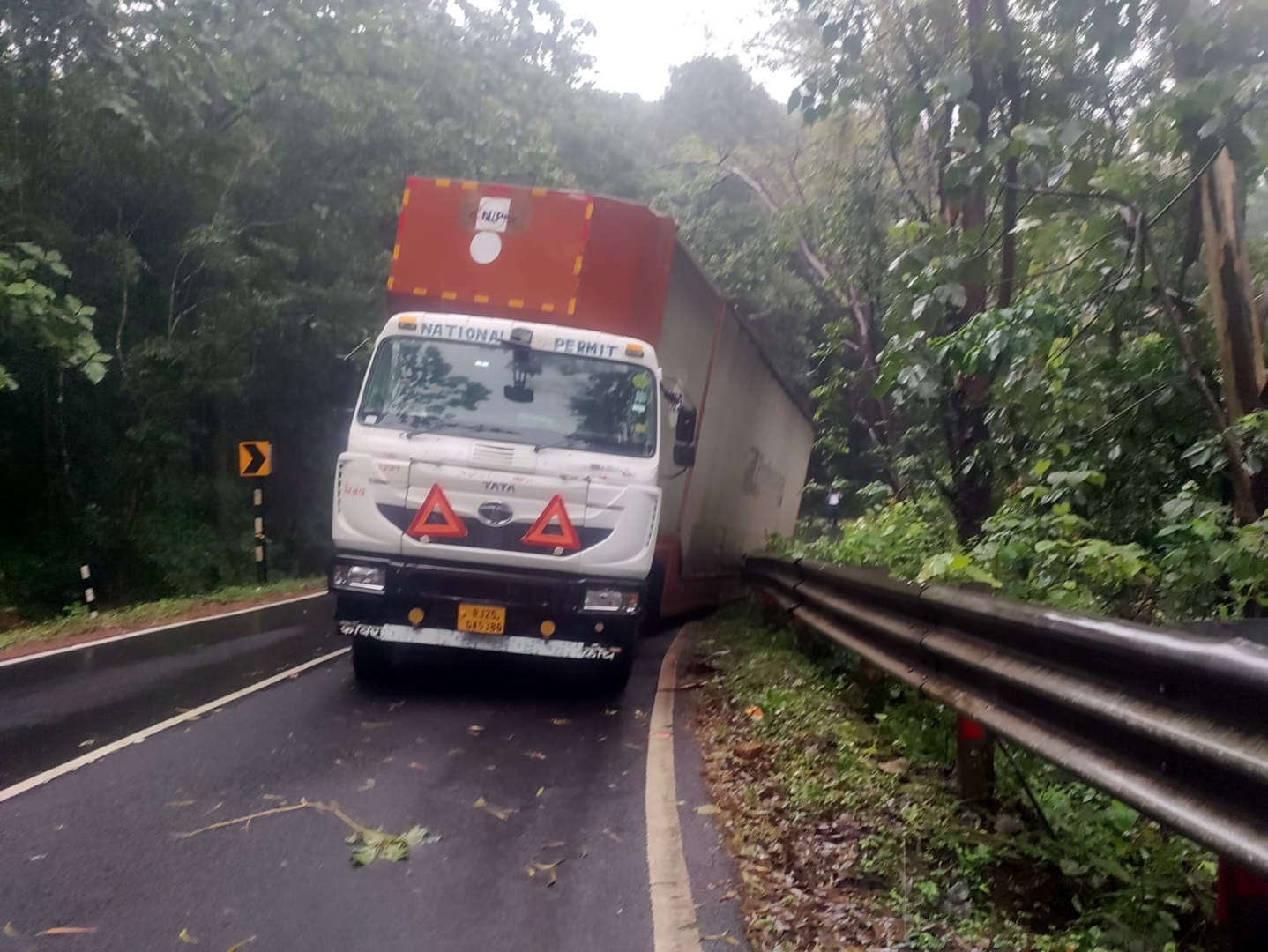 Traffic disrupted as container truck hits crash barriers at Karmalghat