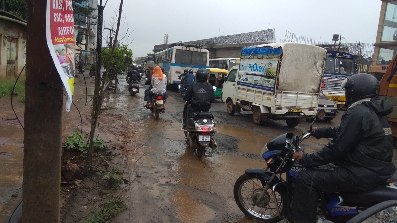 Potholed road near Belagavi   Railway gate irks tourists